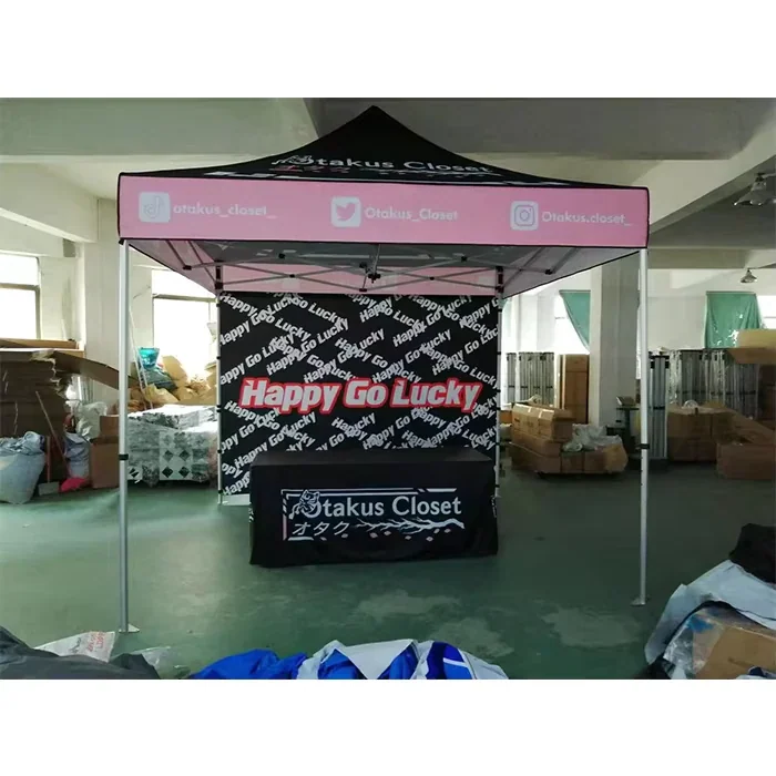 Real 10 by 10 foot pop-up event tent with a printed canopy, full wall and branded counter layout
