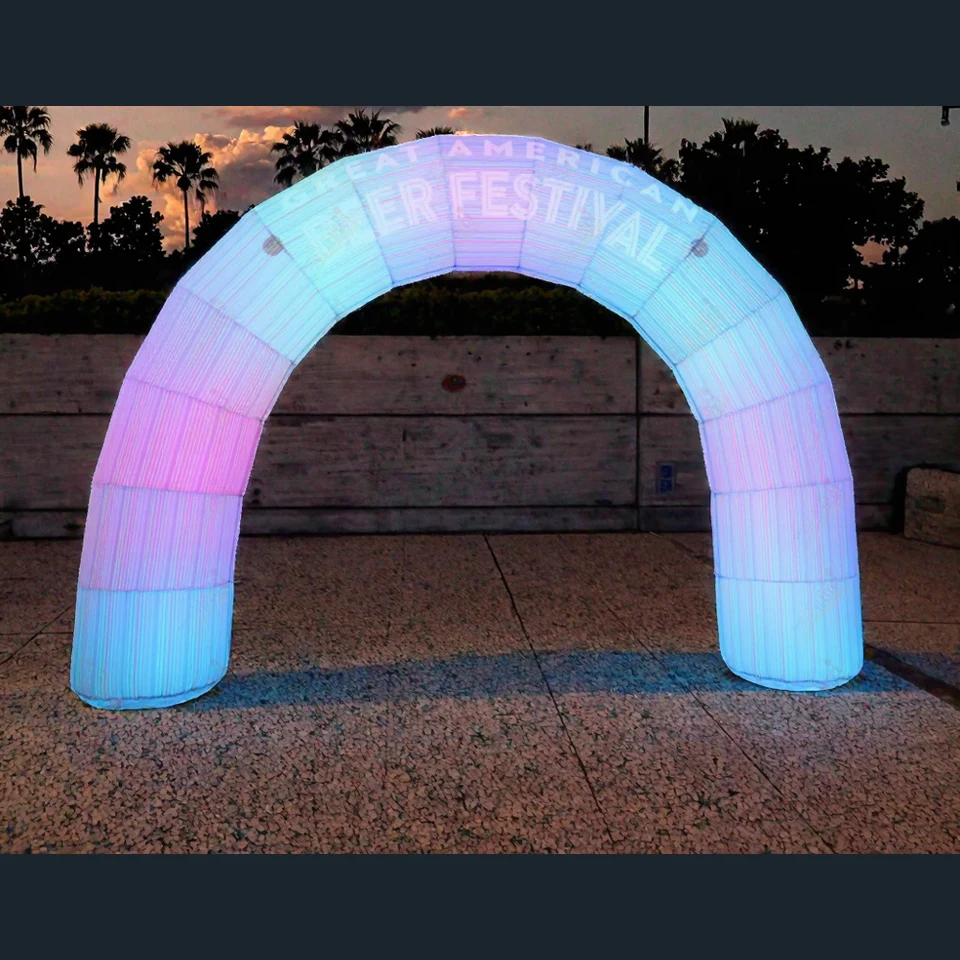 Real illuminated freestanding inflatable arch installed at an outdoor event entrance