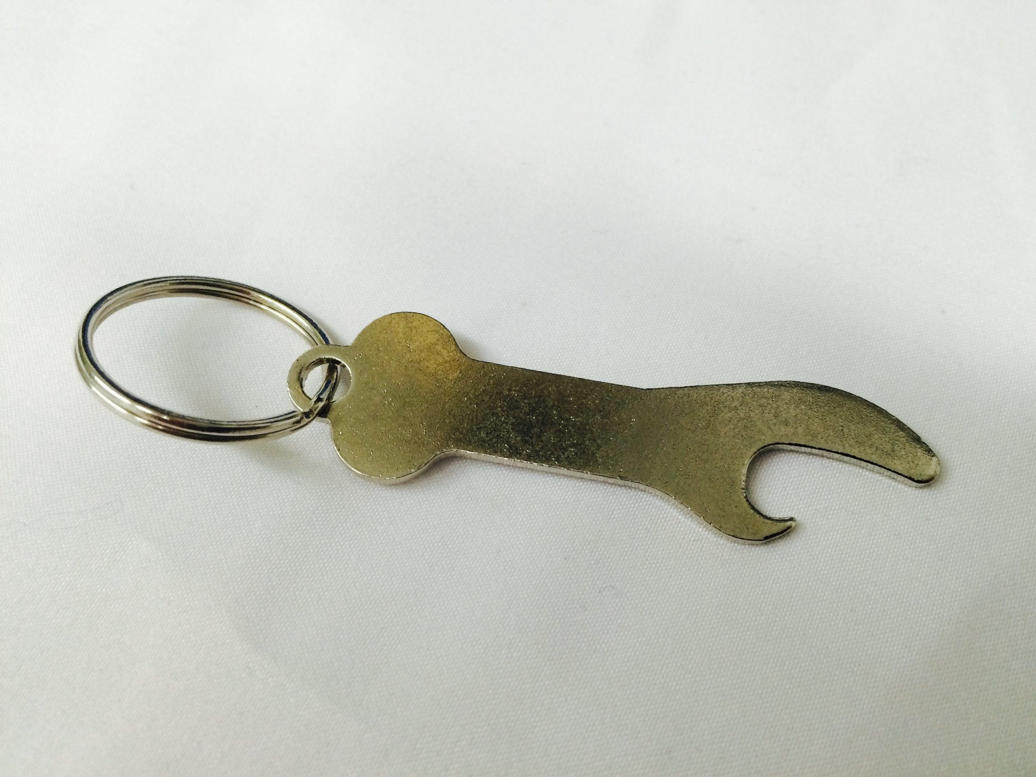 Flat metal bottle opener with a keyring attachment